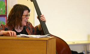 Double bass player Gemma Ashcroft of Sinfonia Cymru enjoying a music workshop in Llandrindod Wells